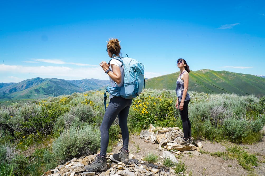 Two hikers looking out at mountain scenery on the Proctor Mountain Loop Trail in Sun Valley Idaho 