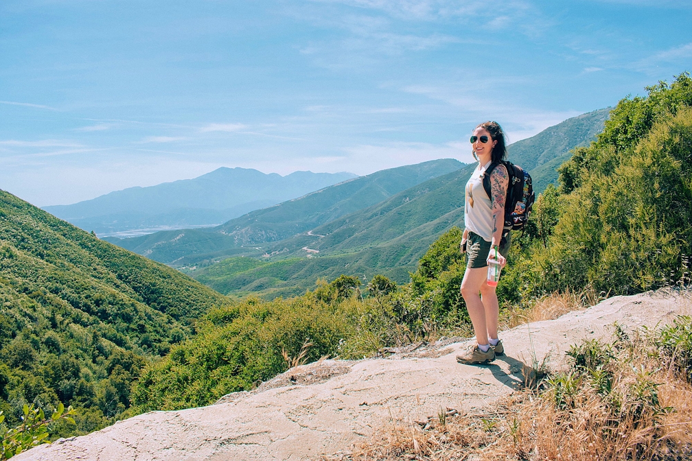 Woman standing and overlooking the scenery at Marshall Peak in San Bernardino National Forest