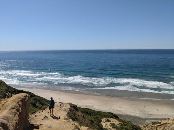 Woman walking down towards Blacks Beach in La Jolla 