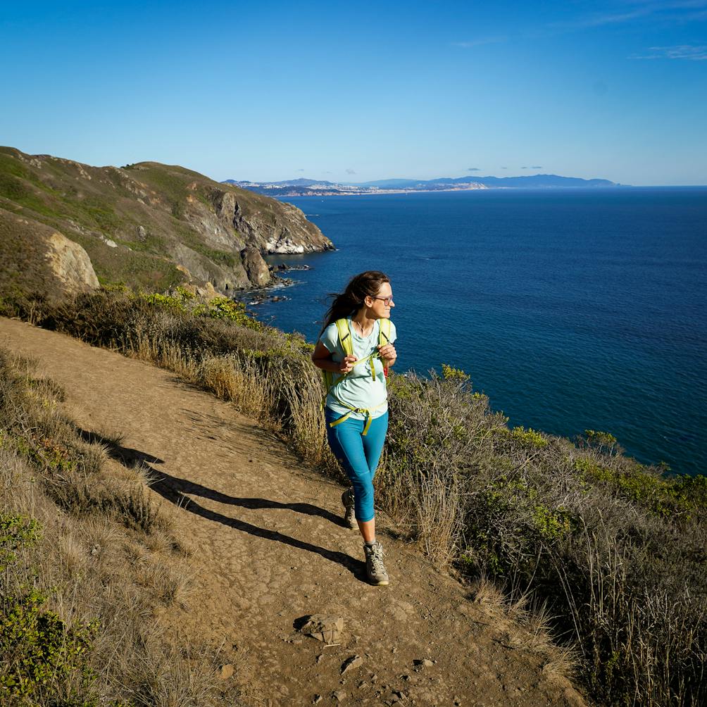 Woman hiking along the Coastal Trail in the Marin Headlands