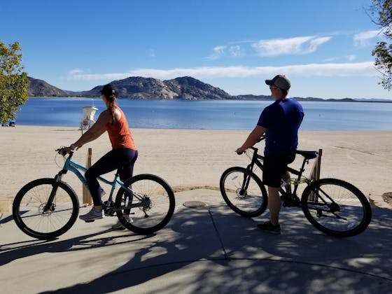 Two bikers looking at the lake at Lake Perris State Recreational Area