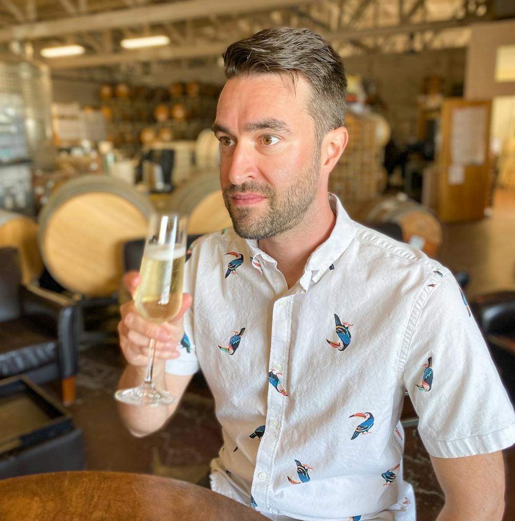 Young man tasting sparkling wine at Riggers Loft in the historic Richmond Shipyard 