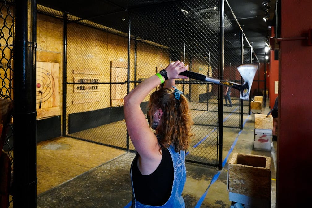 woman throwing an axe at Reno Axe