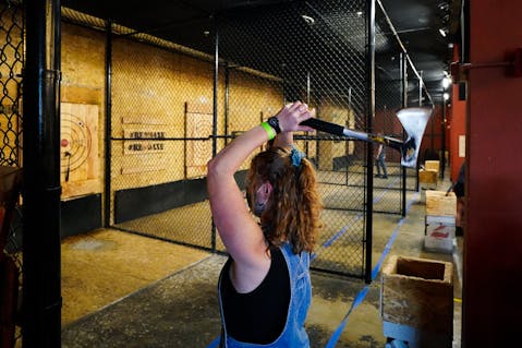 woman throwing an axe at Reno Axe
