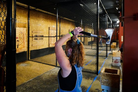 woman throwing an axe at Reno Axe
