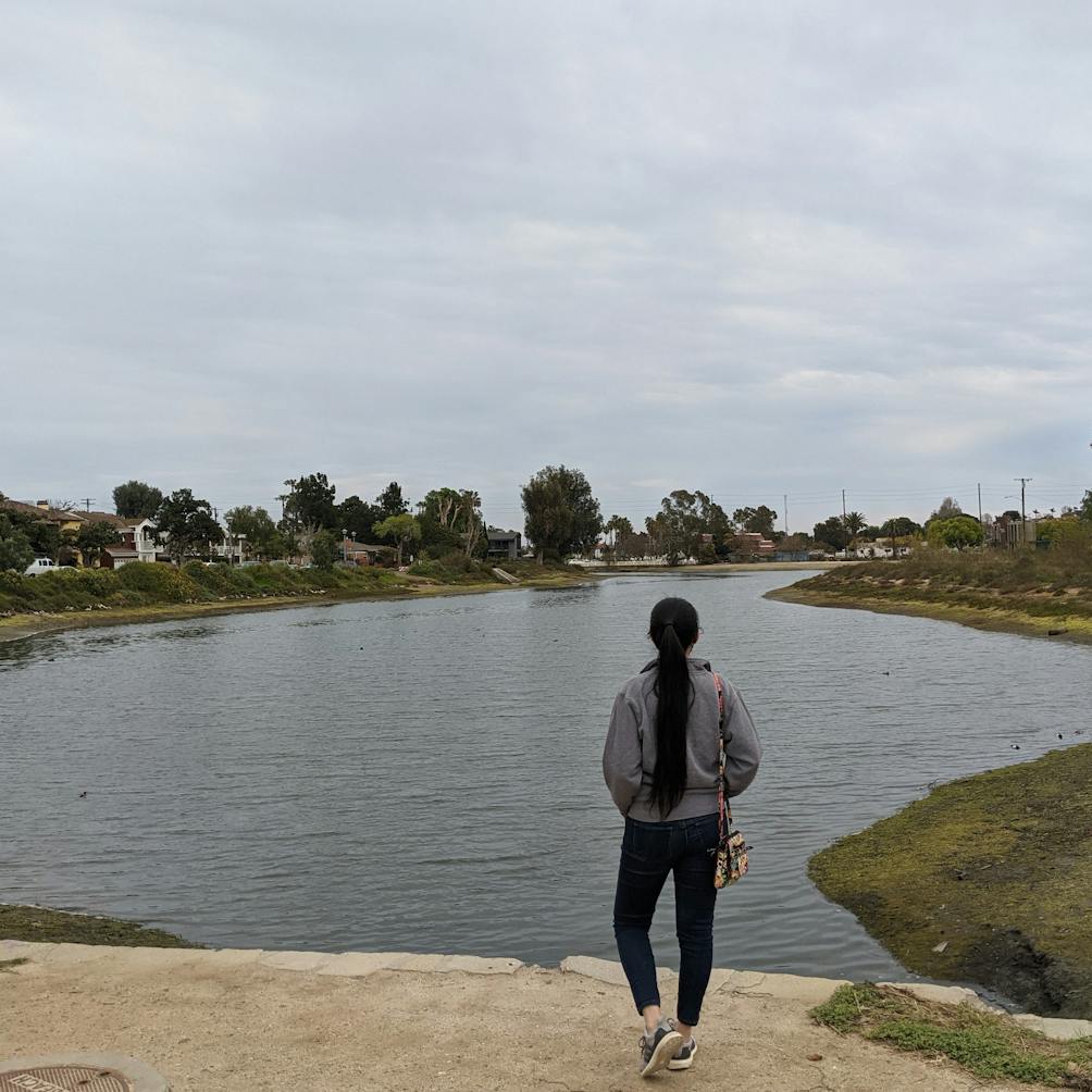 Woman standing and overlooking the Colorado Lagoon in Long Beach Los Angeles County 