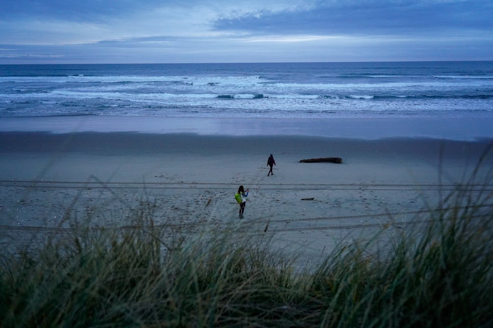 Hikers at Beach after hiking through Taylor Dunes at Oregon Dunes National Recreation Area