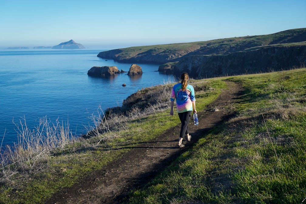 Hiker walking along the North Bluff Trail on Santa Cruz Island, Channel Islands National Park 