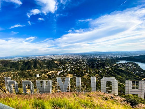 The Hollywood Sign Letters from behind overlooking the Los Angeles skyline 