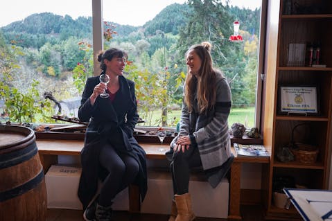 Two women wine tasting in Elkton, Oregon at Rivers Edge Winery 