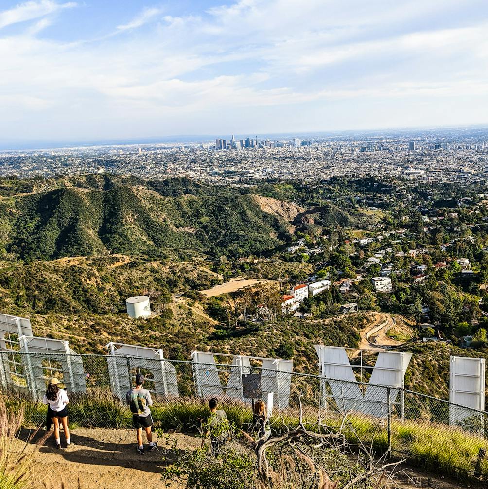 View of the Hollywood sign from behind on a hiking trail in Los Angeles 