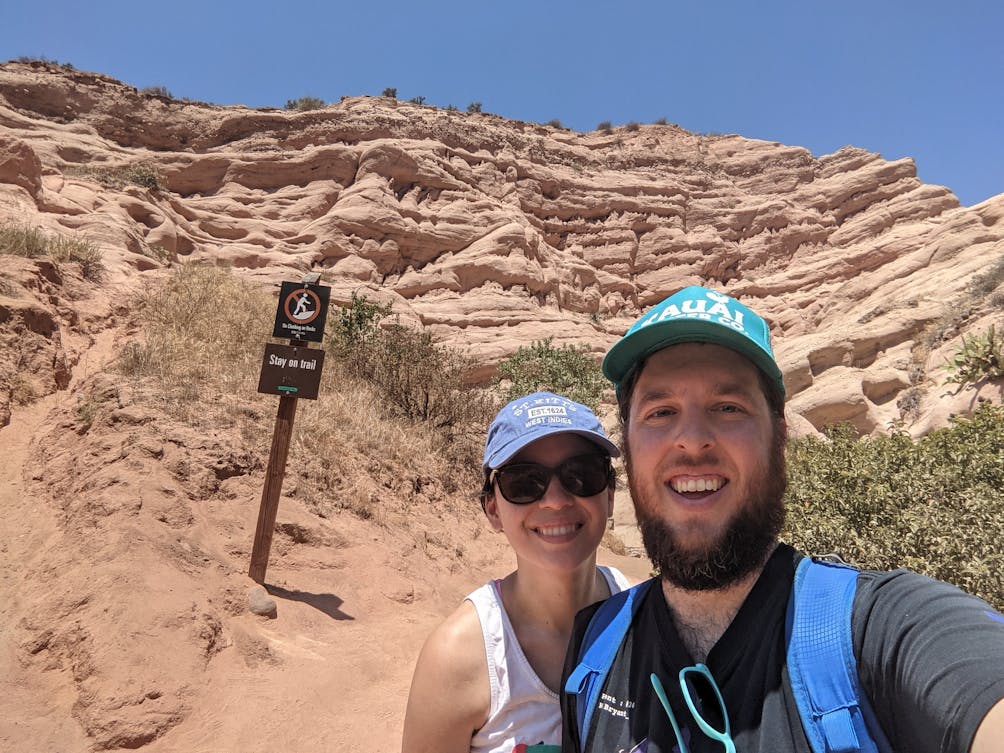 Couple taking a selfie in front of a red rock formation in Whiting Ranch Wilderness Park in Orange County 