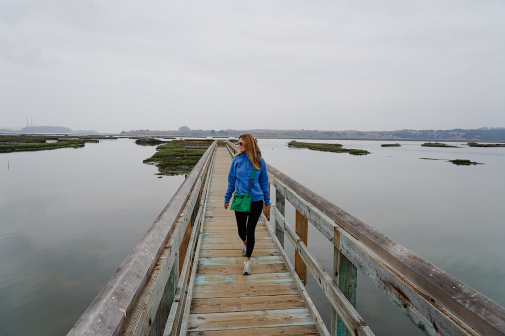 woman hiking Elkhorn Slough Reserve in Monterey