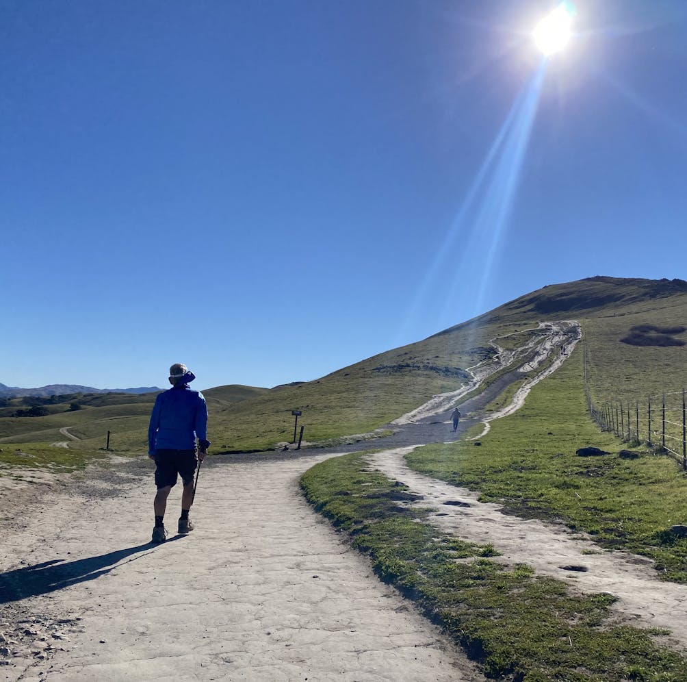 Person hiking on the trail leading up to Mission Peak in the East Bay 