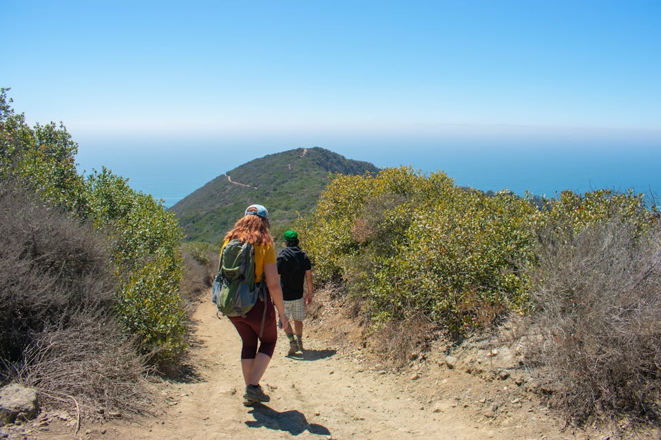 Hikers going down to Coast Royale Beach in Orange County 