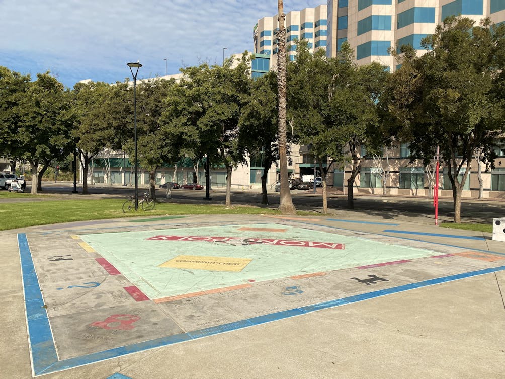 Giant Monopoly board game inscribed in park space in San Jose along the Guadalupe River Trail 