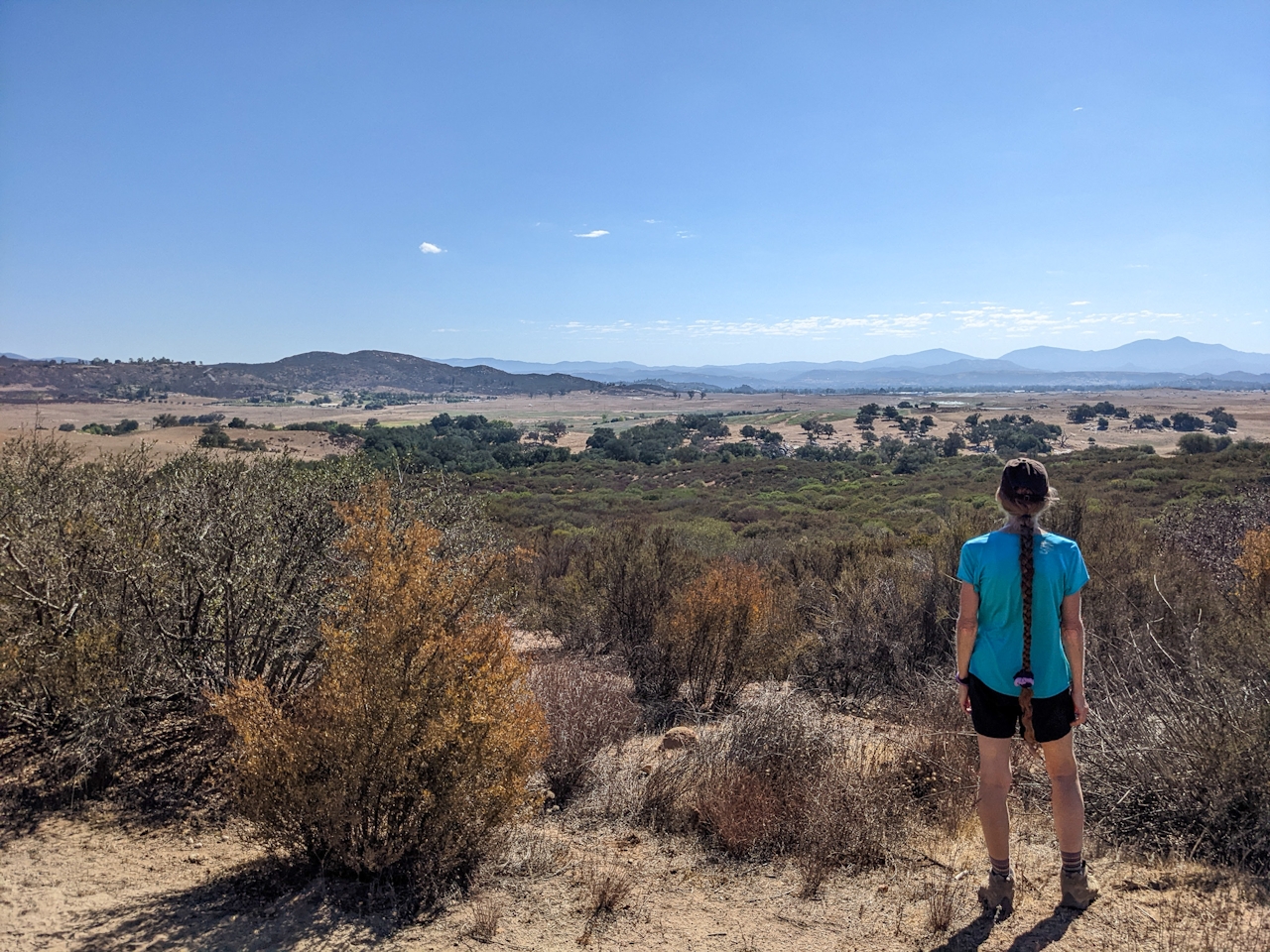 Hiker looking out to the view at Ramona Grasslands Preserve in northern San Diego County 