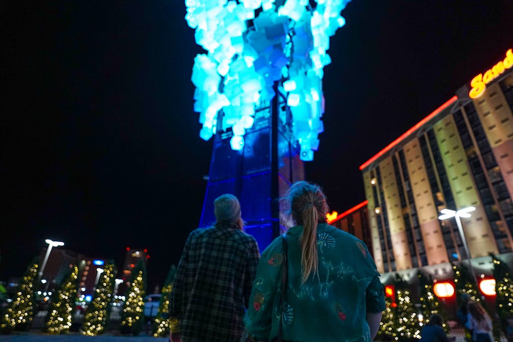 couple looking at neon art on neon line in Reno