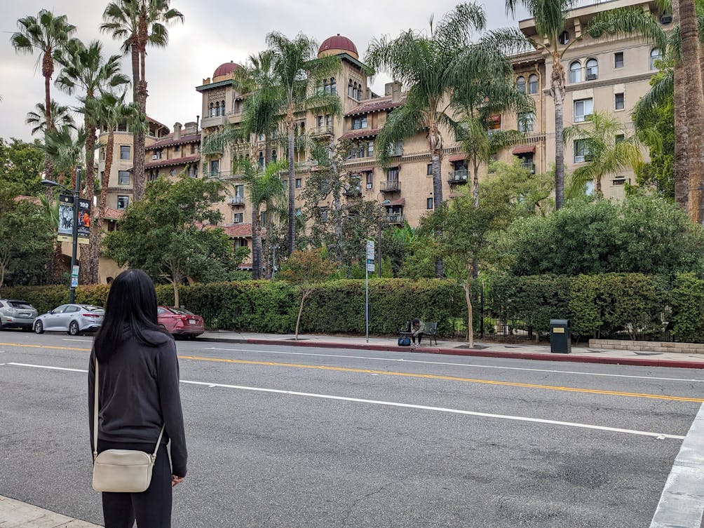 Woman looking over at the Castle Green apartment building in Pasadena 