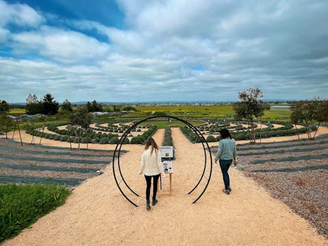 Two women at the entrance of the Lavender Labyrinth at Bees N Blooms in Santa Rosa