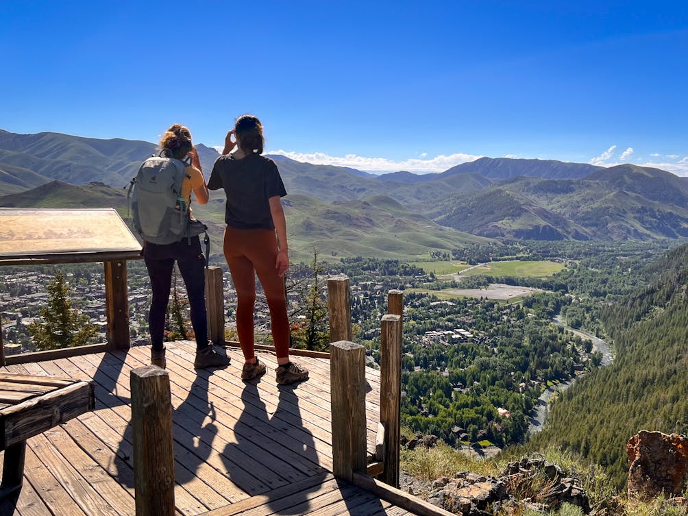 Two hikers overlooking Ketchum from the Scenic Overlook on Bald Mountain in Sun Valley Idaho 