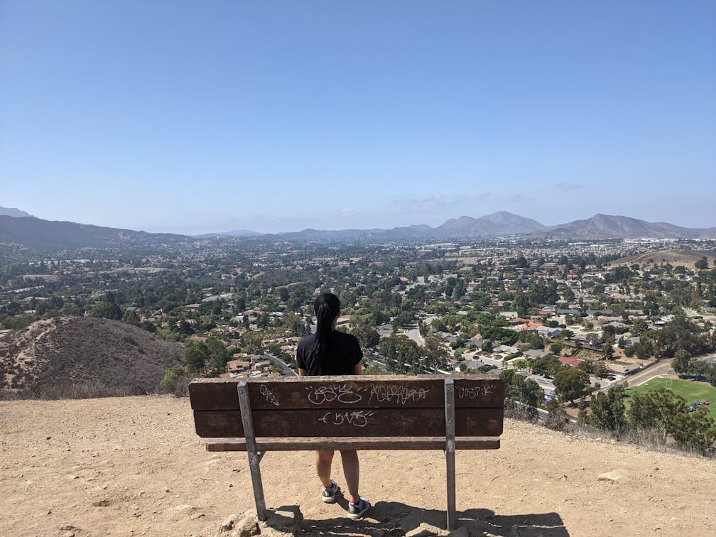 A woman sitting on a bench at the top of Tarantula Hill in Thousand Oaks California 