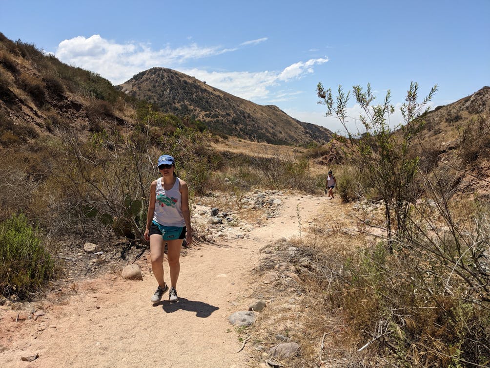 Woman hiking on Borrego Canyon Trail in Whiting Ranch Wilderness Park in Orange County 