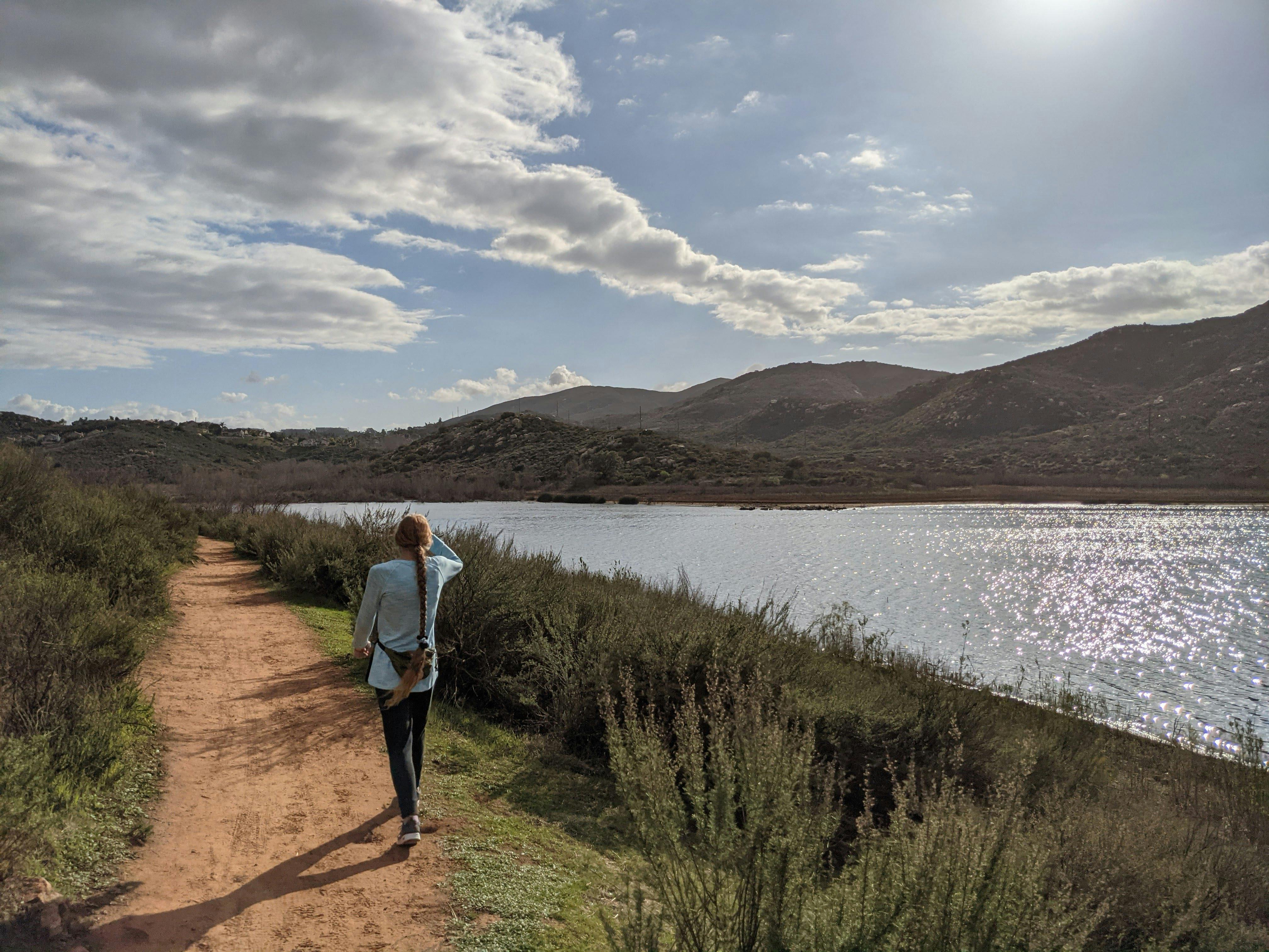 Woman hiking lakeside at Lake Hodges in San Diego County 