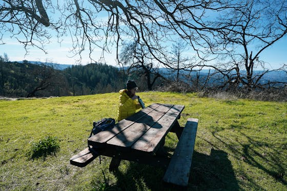 Woman sitting at the picnic table at Lawson picnic area in Hood Mountain Regional Park 