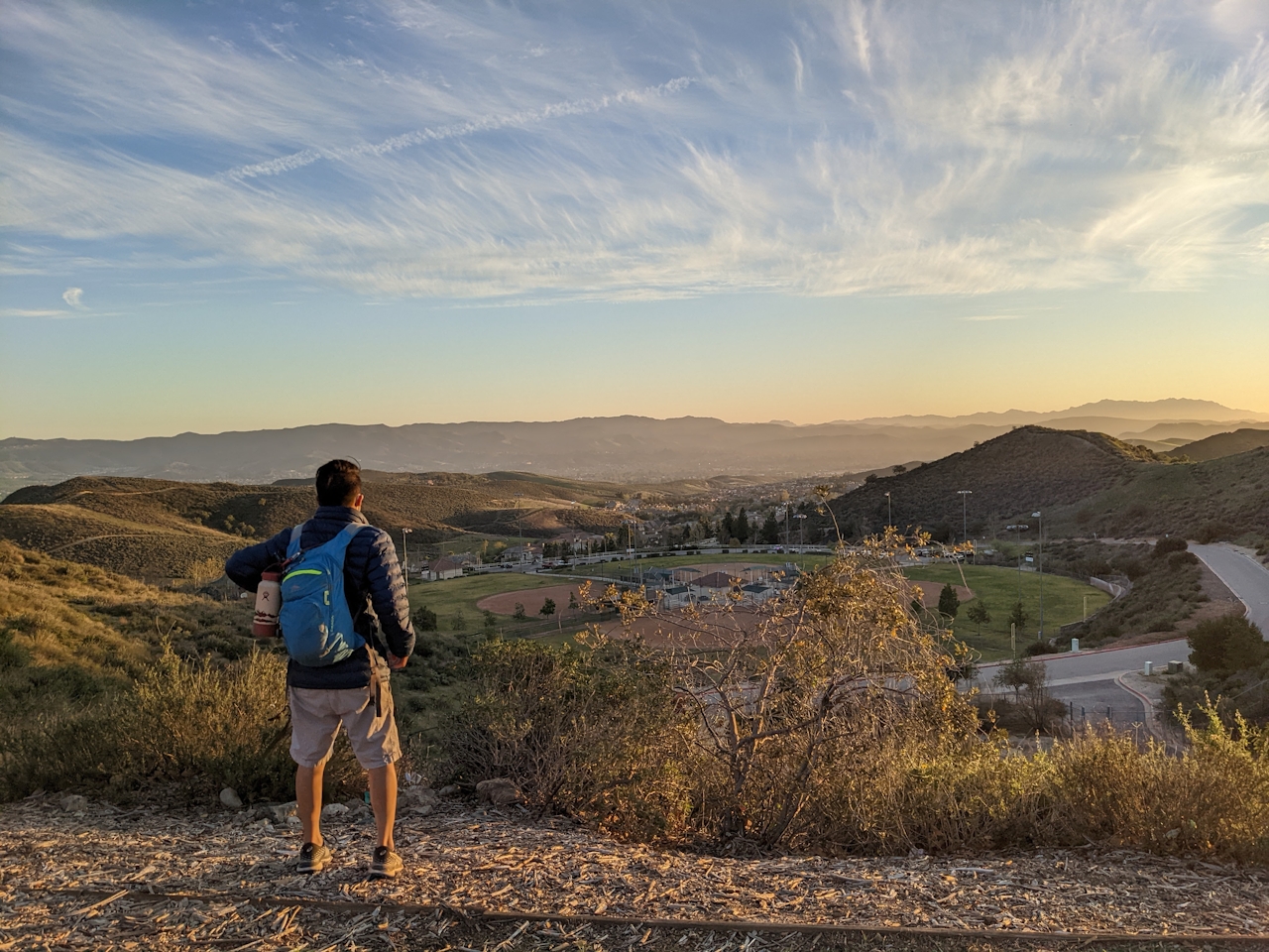 Hiker looking out to huge mountain and sky views at Big Sky Trail in Simi Valley 