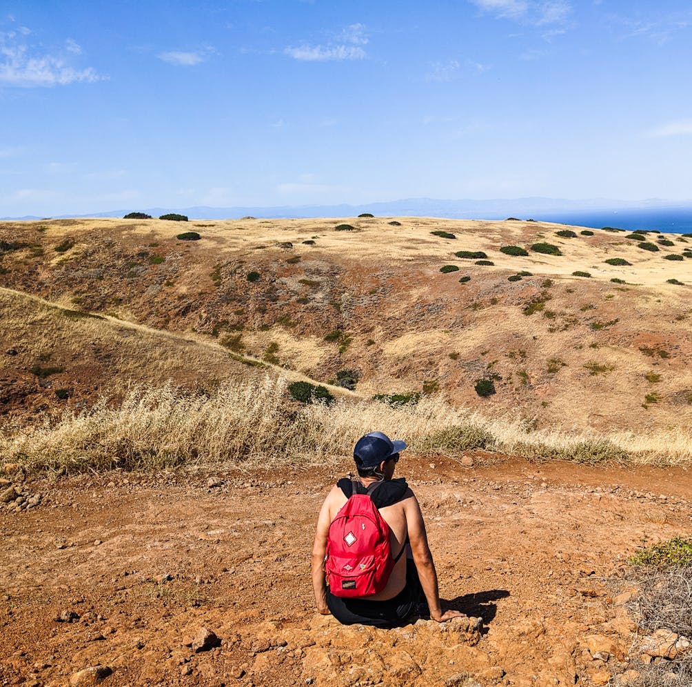 Hiker sitting down for a break at Santa Cruz Island Channel Islands National Park 