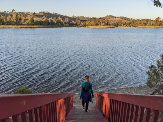 Woman hiking down stairs at Lake Miramar in San Diego County