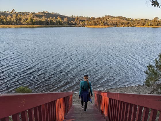Woman hiking down stairs at Lake Miramar in San Diego County 