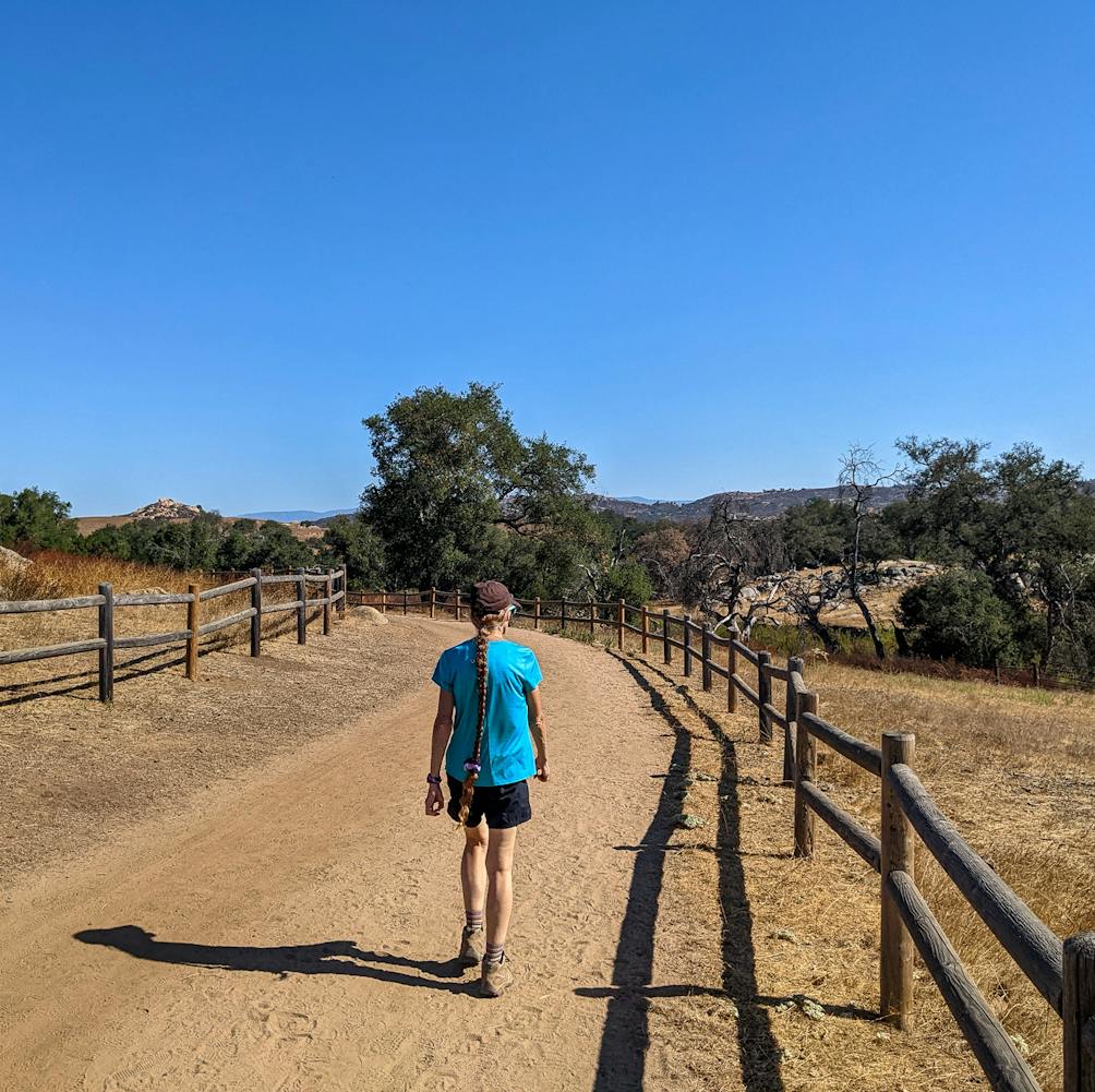 Hiker on a trail at Luelf Pond County Preserve in northern San Diego County 