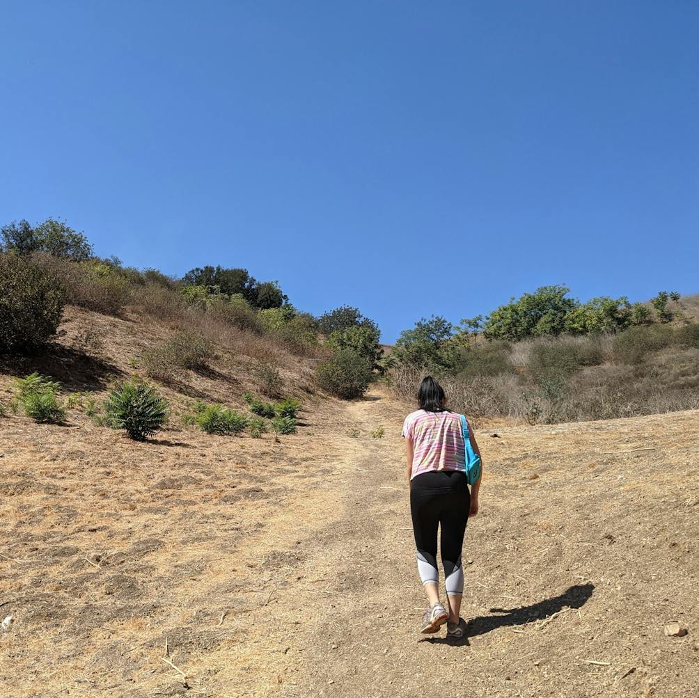 Hiker going up a trail at Elephant Hill Open Space in Los Angeles 
