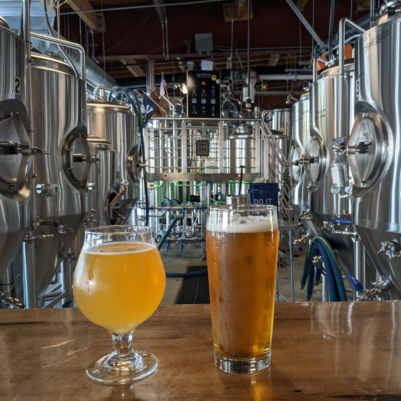 Two beers in front of beer making equipment at Tarantula Brewing Company in Thousand Oaks California 