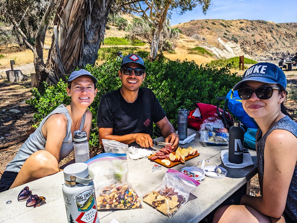 Friends enjoying a picnic at Smugglers Cove on Santa Cruz Isladn Channel Islands National Park 