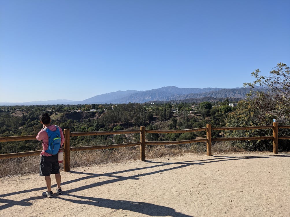 Hiker standing overlooking mountain scenery at The Antonovich Trail in San Dimas