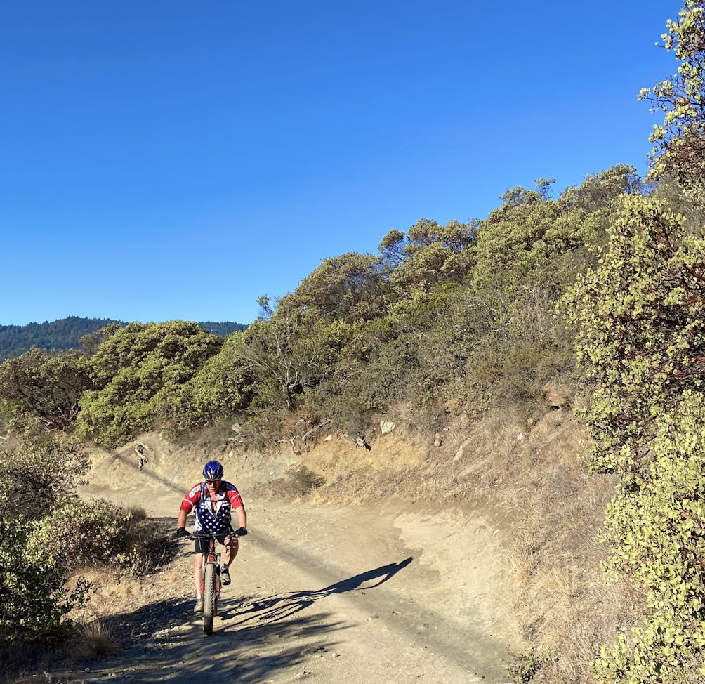 Mountain biker going up a trail at St. Joseph's Hill in Los Gatos 