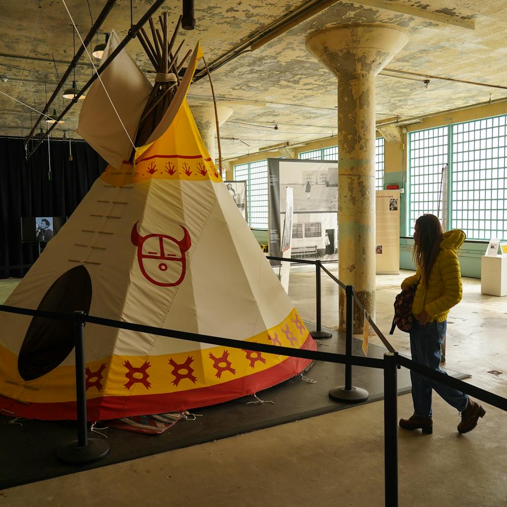 Woman looking at a teepee installation at the Red Power On Alcatraz exhibit on Alcatraz Island 