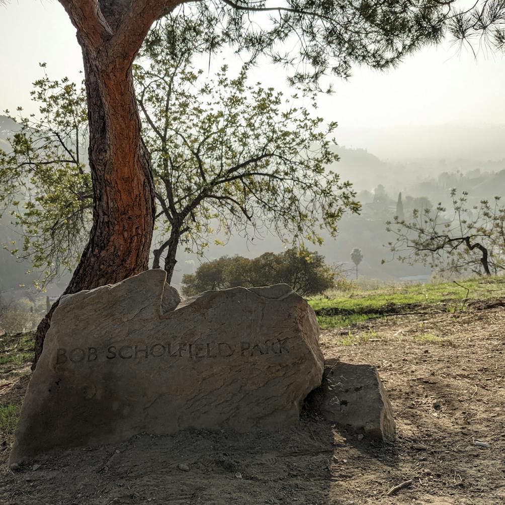 Elyria Canyon Park stone sign in front of an oak tree