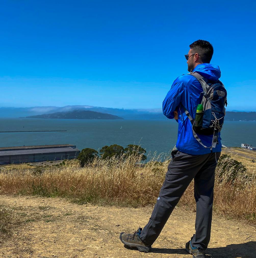 Hiker at Miller Knox Regional Shoreline checking out the Bay Area scenery including Angel Island 