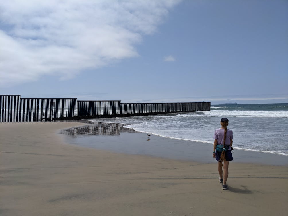 Woman walking on the beach at Border Field State Park in San Diego County 