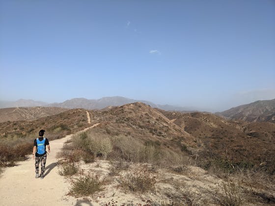 Hiker walking along a long trail at Shadow Hills near Burbank