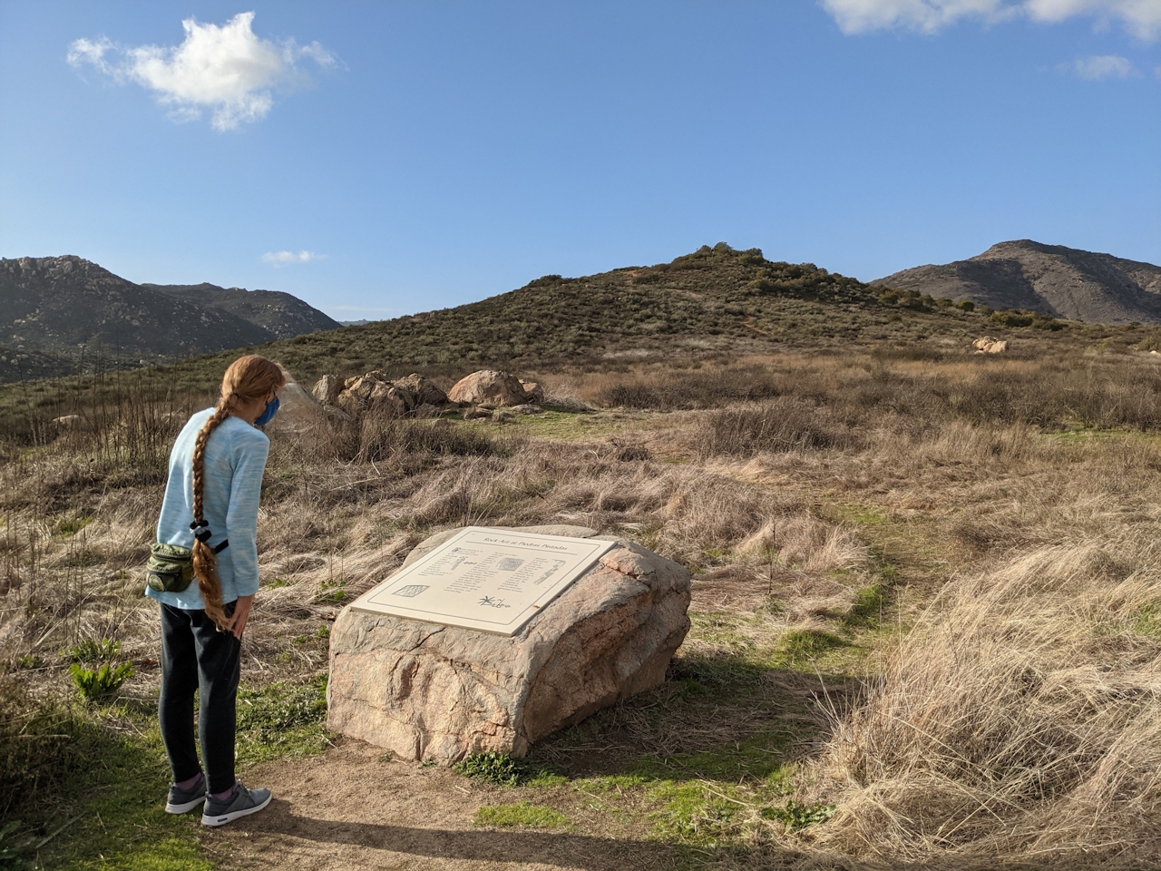 Woman looking at a placard rock sign at Lake Hodges Escondido San Diego County 