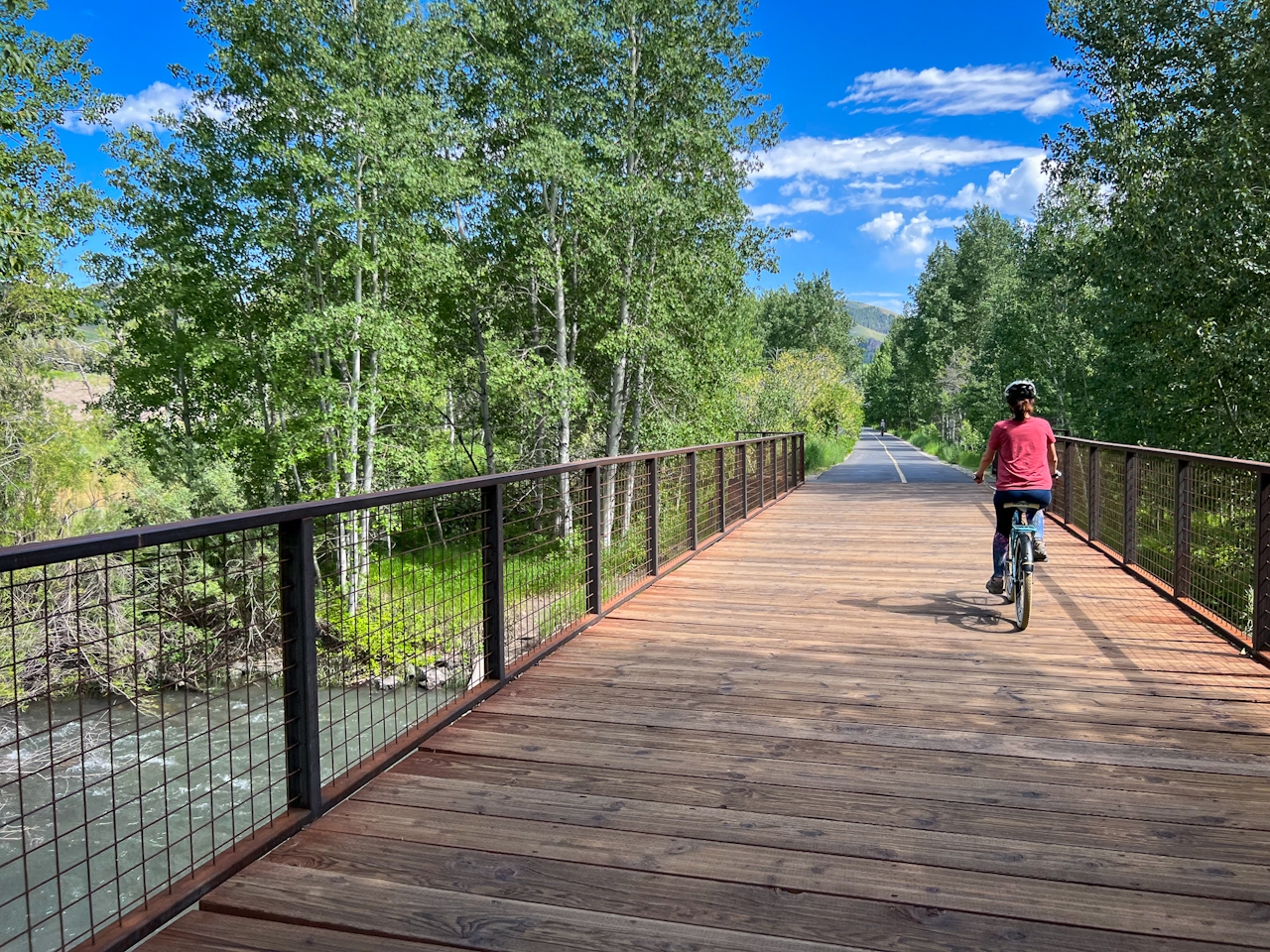 Cyclist crossing a bridge on the Wood River Trail in Sun Valley Idaho 