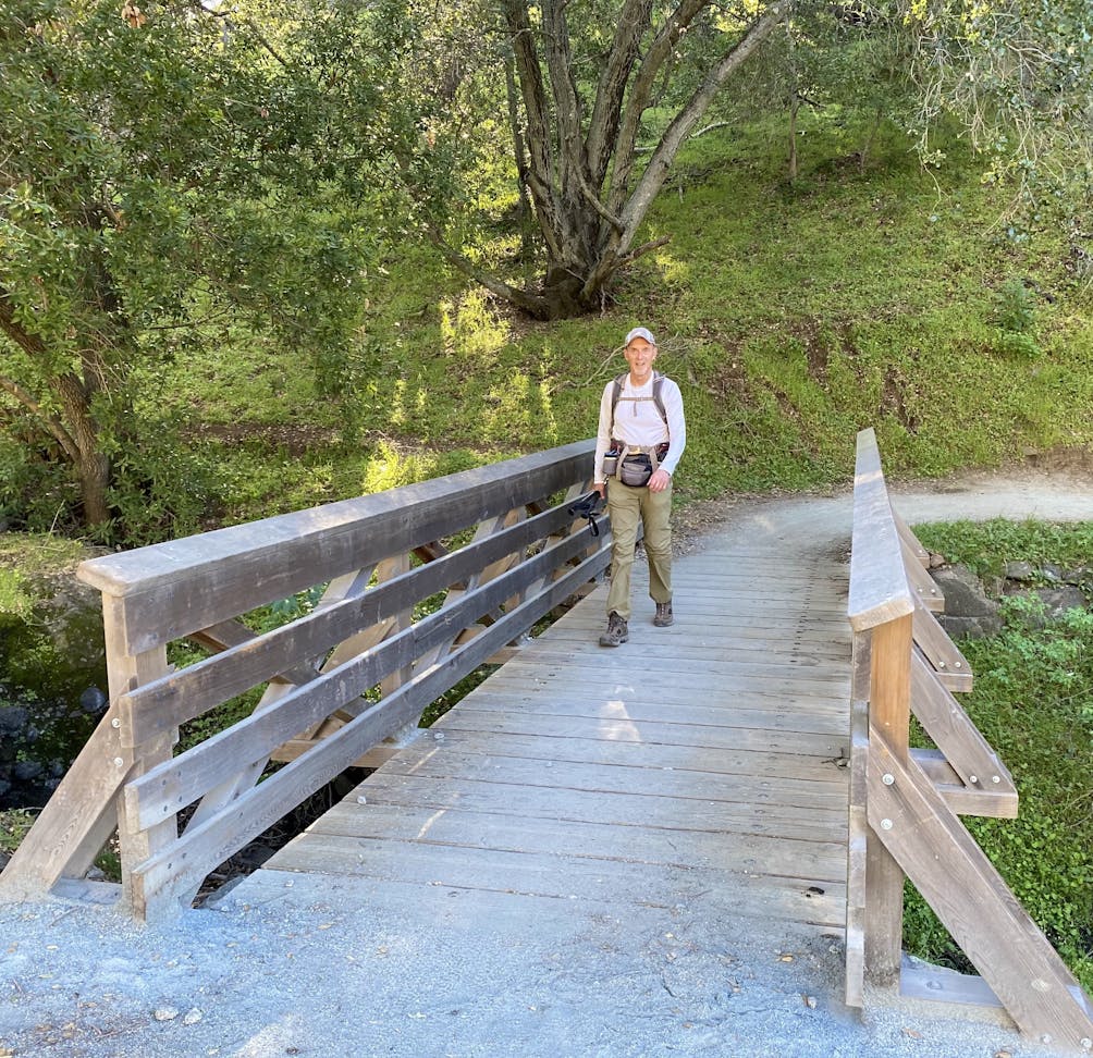Hiker crossing at bridge at Calero County Park in the South Bay 
