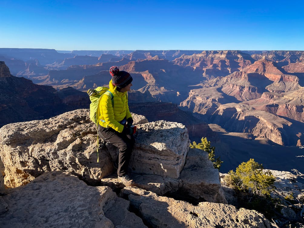 woman at sunset on rim of Grand Canyon