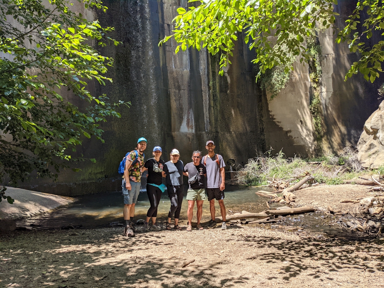 Group of friends gathered in front of the historic Brown Mountain Dam, getting a photo