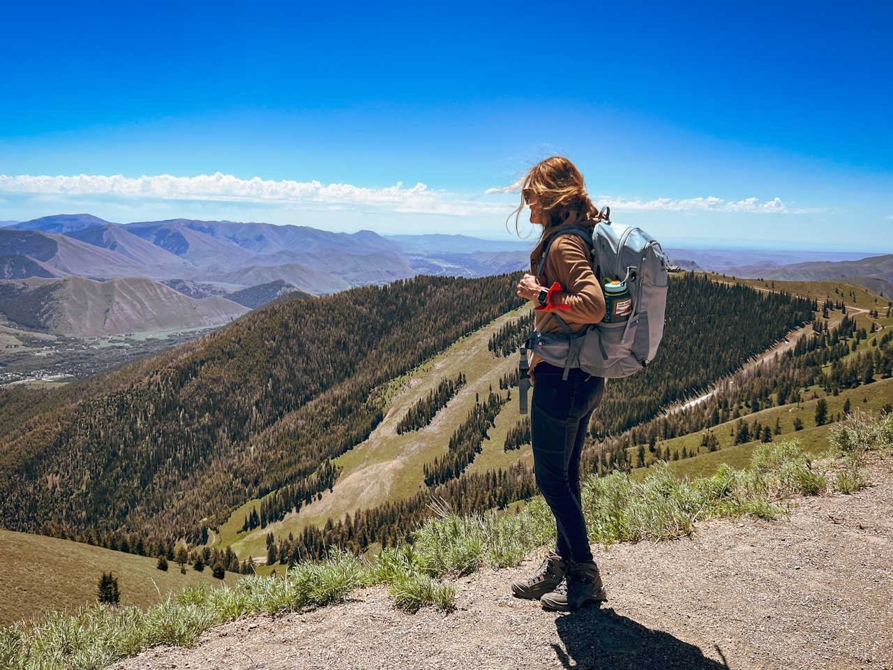 Hiker at summit of Bald Mountain overlooking the ski area in Sun Valley Idaho 